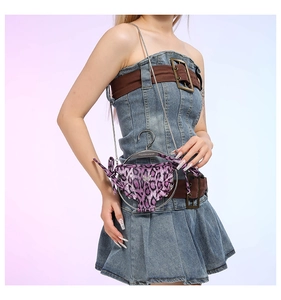 Detail of a purple leopard print mini bikini crossbody bag with silver chain and hanger