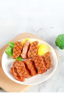 Macro shot of realistic PVC grilled beef models with grill marks and fake garnish