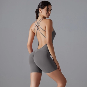 Close-up of cross-back straps and open back detail on a grey yoga bodysuit