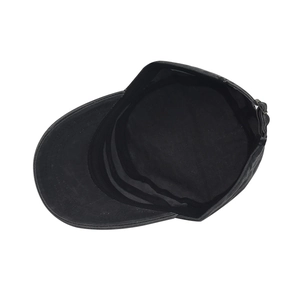 Detail view of the black cadet cap inner sweatband and bronze metal adjustable buckle