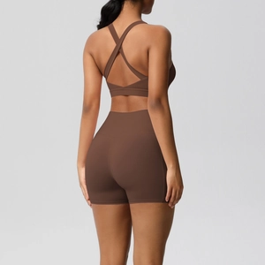 Two-piece dark brown yoga set featuring a cross-back sports bra and high-waisted shorts