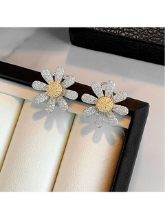 Macro detail of daisy flower earrings with silver petals and yellow cubic zirconia stones