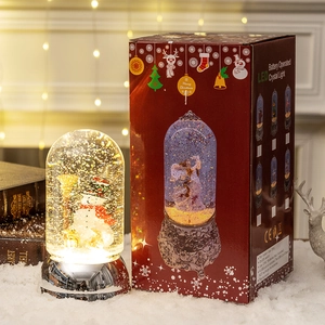 Illuminated Christmas snowman snow globe music box with silver base and red gift box