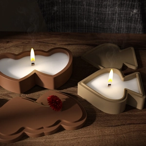 Handcrafted heart and geometric candle molds in matte brown and khaki on vintage wood