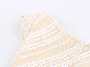 Detailed macro view of beige mesh fabric with shimmering white sequin stripe patterns