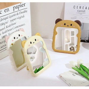 Detailed view of portable cartoon bear ear vanity mirrors in three soft pastel colors