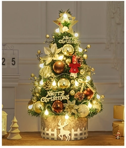 Detail of 60cm gold mini Christmas tree with LED lights and golden ornaments on a table