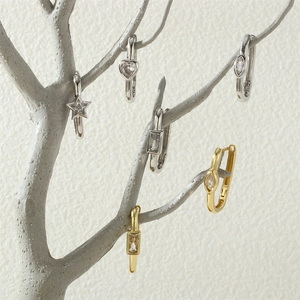 Creative display of heart and star shaped stud earrings with crystals on silver branches