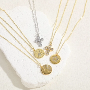 Cross and celestial zircon pendant necklace in gold and silver finish with star detail