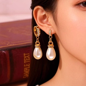 Elegant gold drop earrings with micro-paved diamonds and creamy white waterdrop pearls
