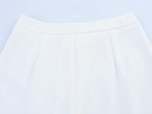 Close-up of white cigarette pants waist featuring smooth fabric and neat stitching detail