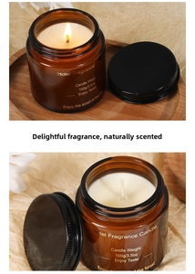 Close-up of a 100g amber glass scented candle with a black lid and forest fragrance label