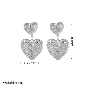 Detailed view of silver heart earrings with crinkled texture and dimension measurements