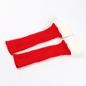 Detail of red knitted leg warmers with white faux fur trim and cozy festive design
