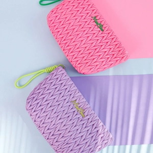 Pink and purple woven leather cosmetic bags with gold logo and matching handles