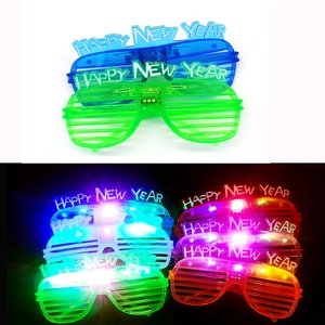 Detail view of LED light up shutters glasses with Happy New Year text in blue and green