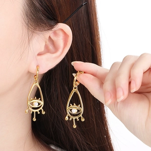 Boucles d'oreilles ethniques en or avec œil protecteur, perles et cristaux en forme de V