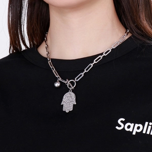 Detail of silver Hamsa Hand necklace with OT toggle clasp worn by a model