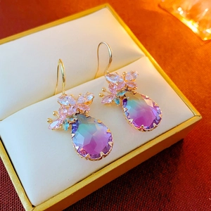 Detail of water drop earrings with purple gradient gemstone and zircon floral cluster