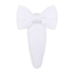 Macro detail of a white grosgrain ribbon hair clip with a bow and teardrop base