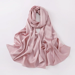 Detail view of the soft pink chiffon fabric texture and smooth silk sheen of the shawl
