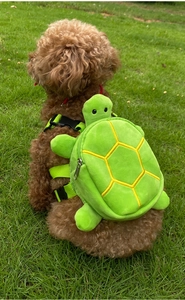 Detail of adjustable green nylon straps and turtle-shaped plush pet backpack on dog