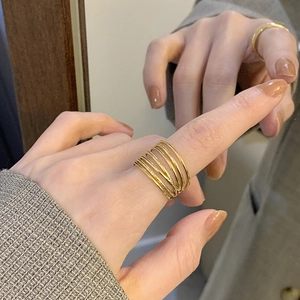 Detailed view of wide multi-layer layered gold plated titanium steel adjustable ring