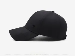 Detail view of the black baseball cap featuring a premium textured fabric and metal side icon