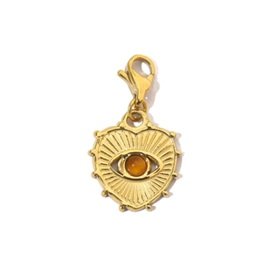 Detailed close-up of a golden heart pendant with amber gemstone and evil eye detail