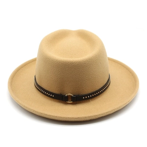 Close-up of khaki fedora with black leather band and gold stud metal ring detail