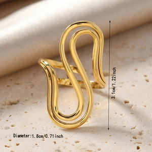Detail shot of gold S-shaped abstract ring with dimensions 3.1cm height and 1.8cm diameter