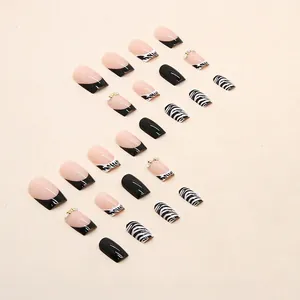 Press-on nail set with zebra stripes and rhinestones in French square style