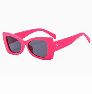 Macro shot of fuchsia butterfly frame sunglasses with triple metal dot hinge detail