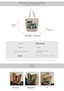 Detail view of woven straw tote bag with Here Comes The Sun text and size specifications