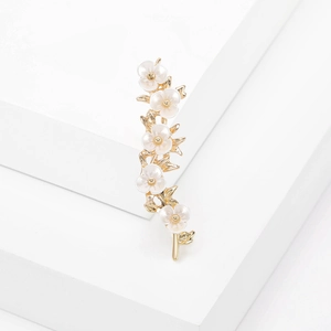 Elegant gold plum blossom branch brooch with white flowers on minimalist geometric stand