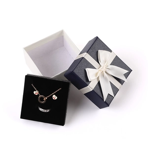 Elegant jewelry gift set with necklace, earrings, and ring in a blue bow box