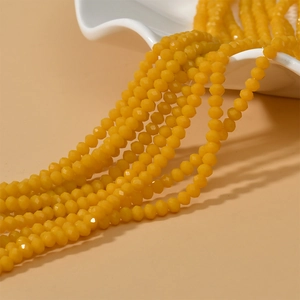 Macro view of 4mm faceted yellow crystal rondelle beads for DIY jewelry making