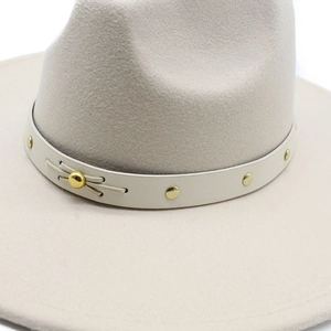 Detailed close-up of cream wool fedora with gold-studded leather band and metal buckle