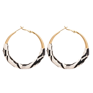 Fashionable round gold hoop earrings with black and white zebra pattern leather wrap