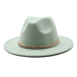 Classic light green fedora wool hat with a decorative gold chain band on white background