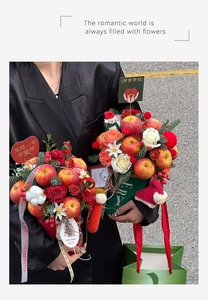Detail of Christmas apple bouquet in red and green tubs with festive decorations