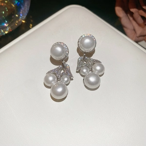 Macro view of flower tassel earrings with Mickey-shaped pearls and micro-set zircons