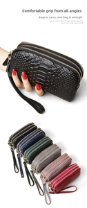 Vertical view of six snakeskin textured clutch wallets with double zippers and wrist straps