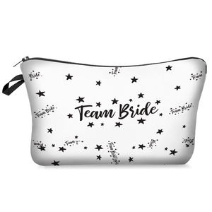 Detail of Team Bride makeup bag with star print, black zipper, and woven handle strap