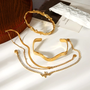 Detailed view of wave-shaped gold-plated jewelry set with sparkling zircon stones