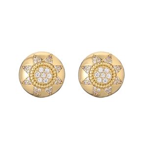 Detailed close-up of golden round stud earrings featuring zircon-encrusted starburst pattern