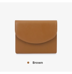 Close-up of a brown minimalist card holder with precise stitching and a curved flap cover
