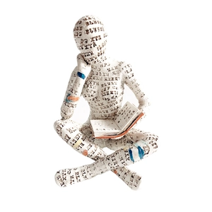 Detailed view of reading woman sculpture with textured paper pattern and colorful accents