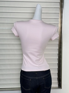 Detail view of pink slim-fit t-shirt back on mannequin with classic crew neck