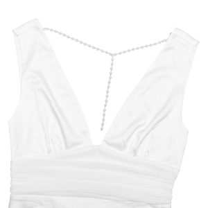 Detail of elegant white deep V-neck dress with decorative pearl chain and waist pleats